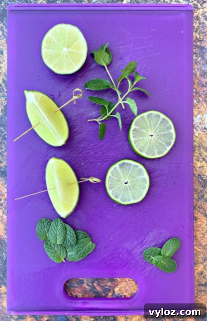 Guilt-Free Keto Mojito 4 fresh limes and fresh mint on a purple cutting board, key ingredients for a keto mojito