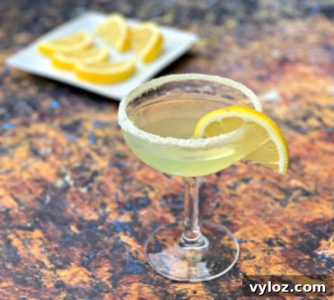 Sugar-Free Keto Lemon Drop Martinis 7 keto low carb lemon drop cocktail in a martini glass with lemon wedges on a white plate