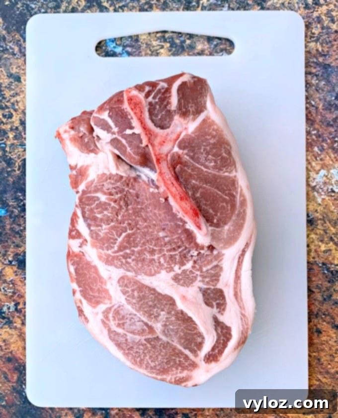 raw pork shoulder butt on a cutting board