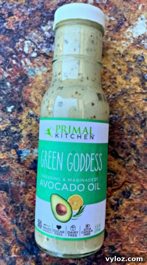 Green Goddess salad dressing in a bottle, ready to elevate the flavor of a healthy salad.