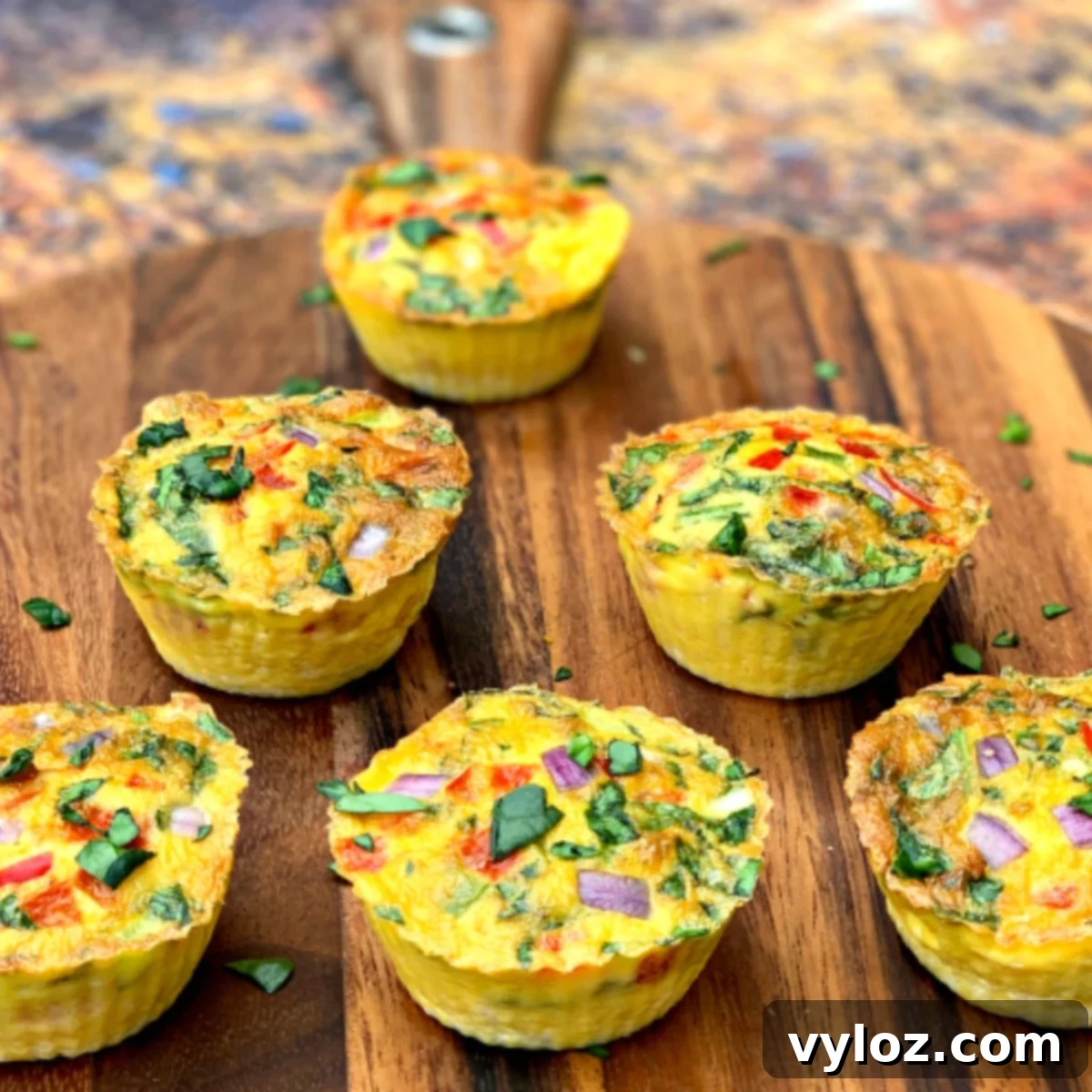 Keto-friendly, low-carb Air Fryer Egg Bites with crispy bacon, served on a rustic brown plate for a healthy breakfast.