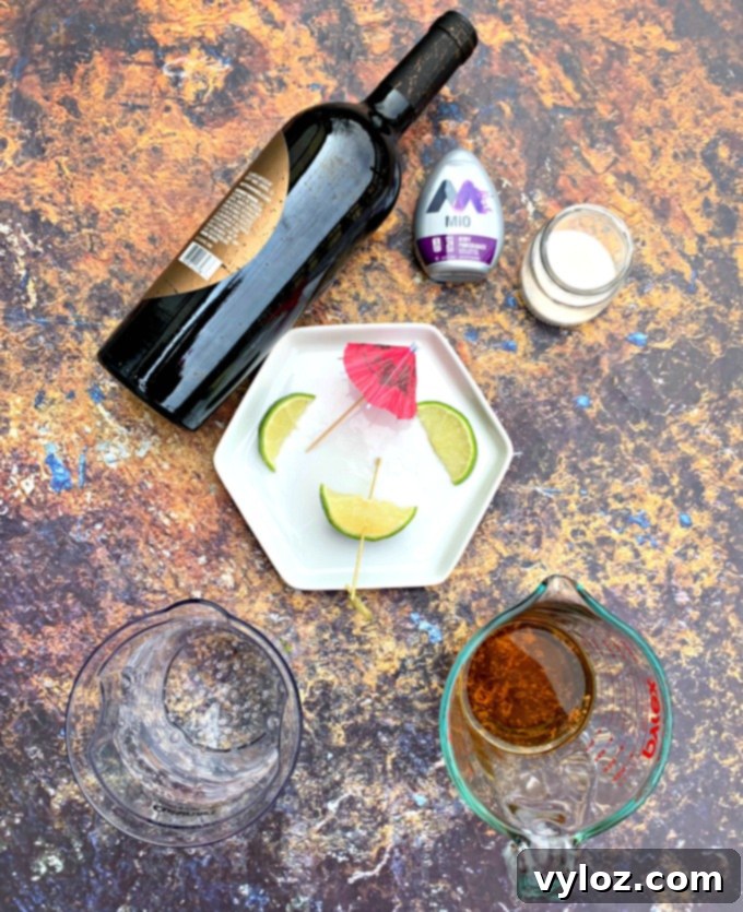 A flat lay arrangement featuring key ingredients for sugar-free sangria: a bottle of red wine, a bottle of brandy, club soda, and fresh limes, ready for preparation.