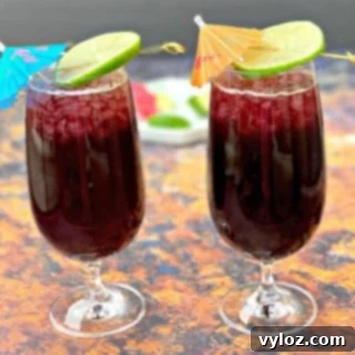 Two glasses of keto low carb red wine sangria with a lime, artfully presented.