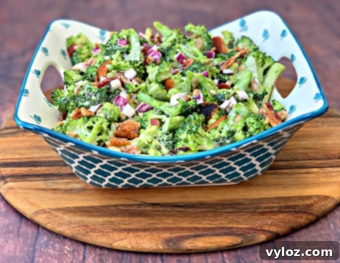 Creamy Keto Low-Carb Broccoli Salad with Bacon, red onions, and sunflower seeds in a blue bowl