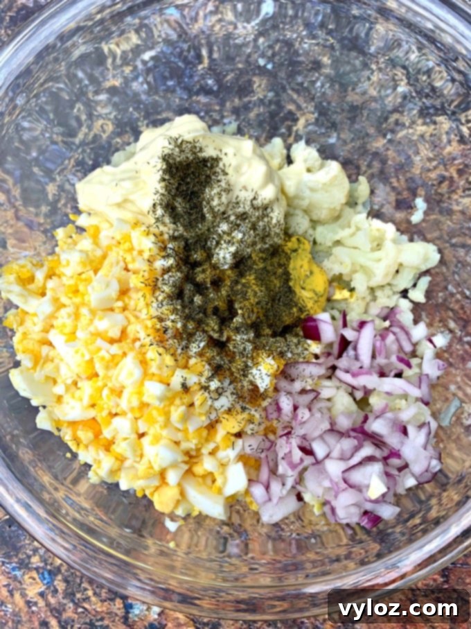 Keto low carb cauliflower potato salad with boiled eggs in a glass bowl