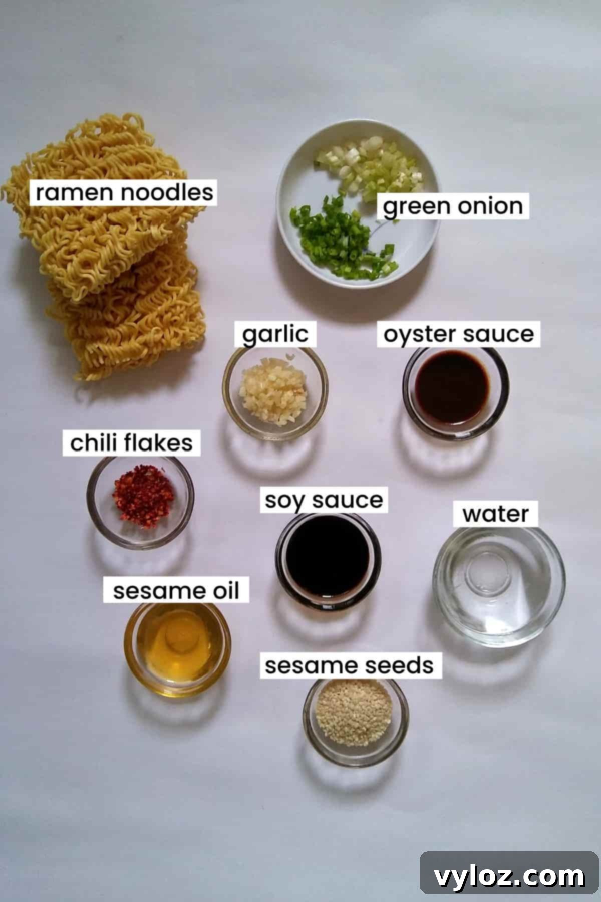 Image showing ingredients for sesame garlic ramen noodles laid out on a white background.