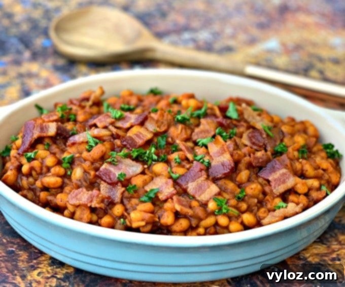 Instant Pot baked beans with bacon in a blue bowl