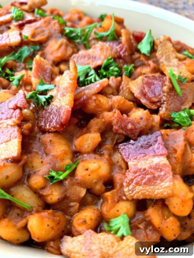 Instant Pot baked beans with bacon in a blue bowl