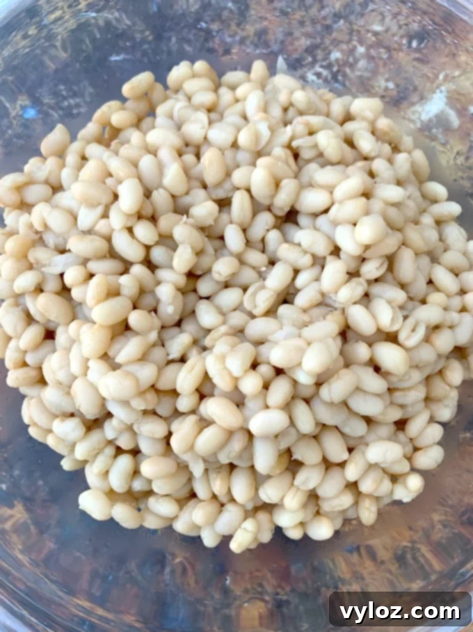 Cooked navy beans in a glass bowl