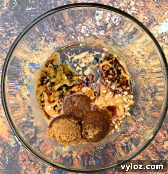 Assortment of ingredients for making a rich and creamy peanut butter dressing for Thai chicken salad