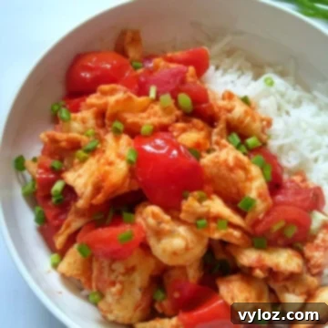 Image showing vibrant looking stir fried tomato egg served over white rice.