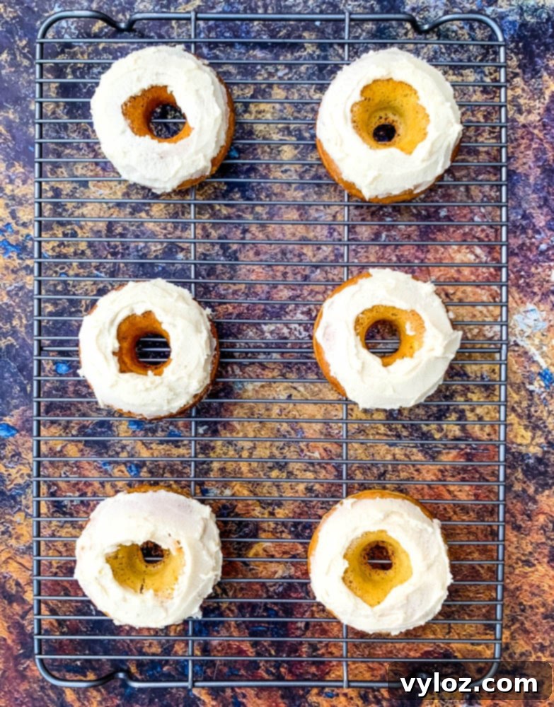 keto low carb donuts with a luscious frosted glaze on a cooling rack