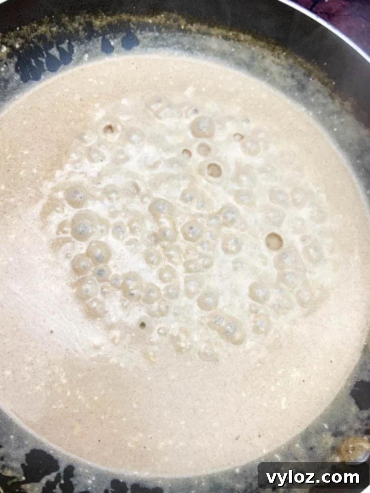 Easy Keto Chicken Broccoli Cheese Bake 6 cream cheese and heavy cream in a skillet