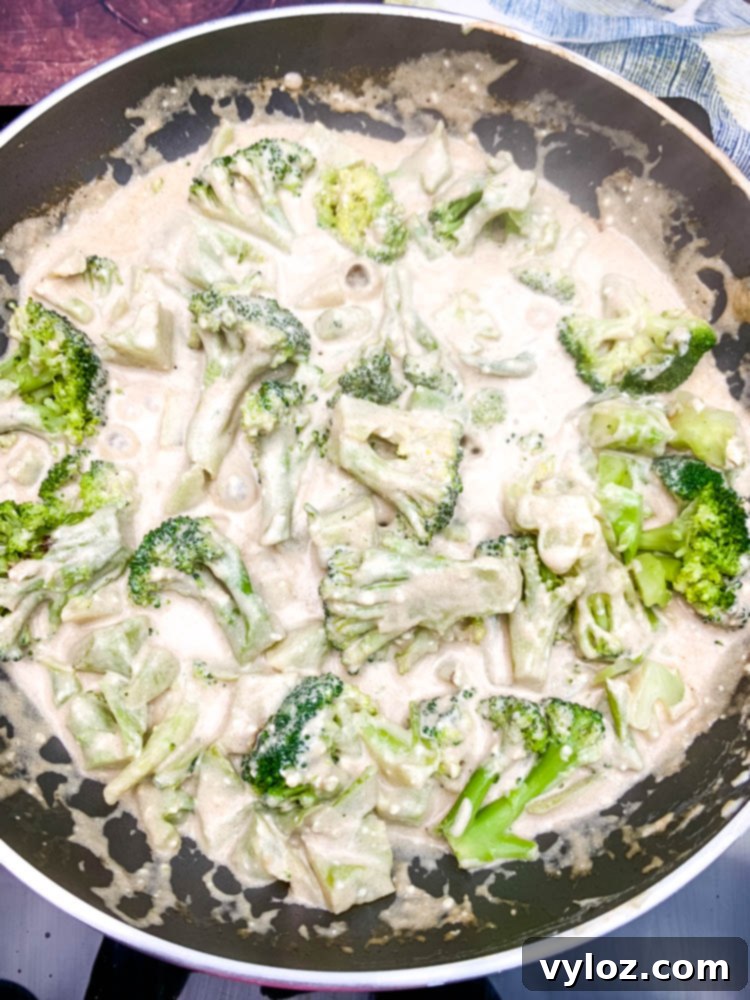 Easy Keto Chicken Broccoli Cheese Bake 7 cream cheese and cooked broccoli in a skillet