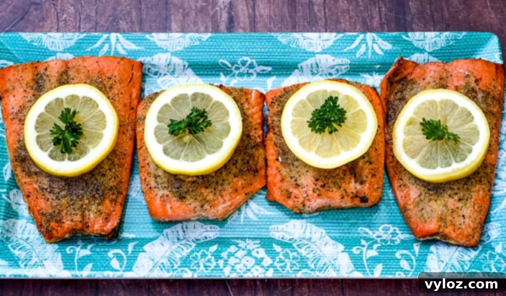 Delicious Air Fryer Salmon Made Simple 5 air fryer salmon on a blue plate with a fresh lemon size