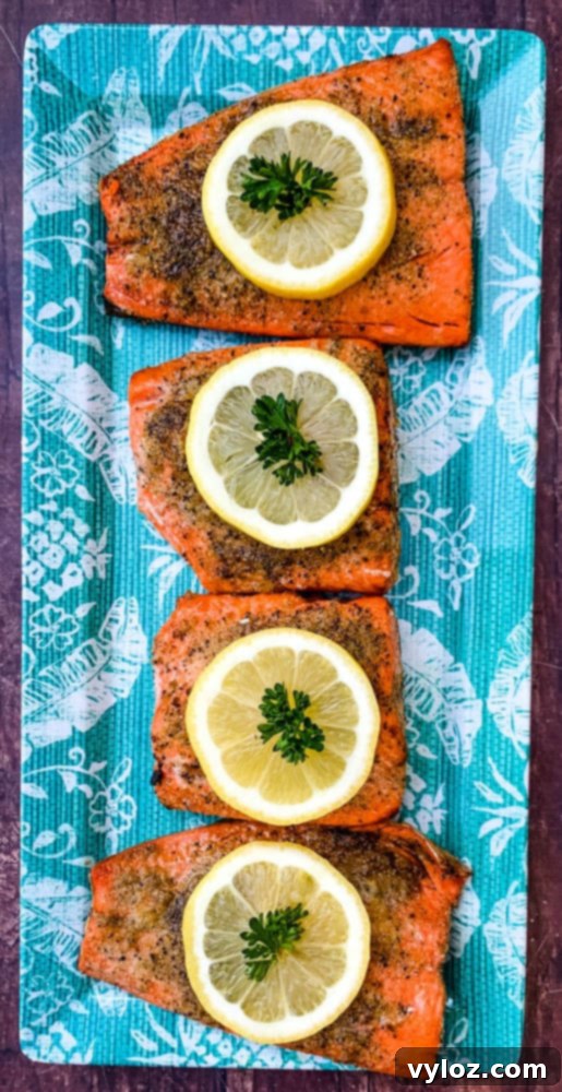 Delicious Air Fryer Salmon Made Simple 7 air fryer salmon on a blue plate with a fresh lemon size