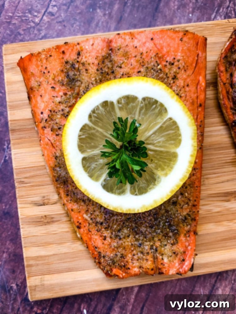 Delicious Air Fryer Salmon Made Simple 8 air fryer salmon on a wooden board with a fresh lemon size