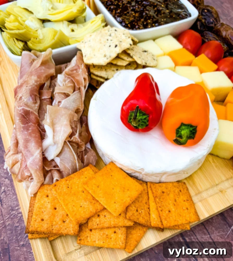 charcuterie board with artichokes, fig spread, cheese, and meat