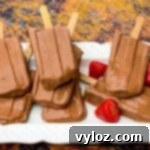 Keto low-carb fudge popsicle bars on a white plate with strawberries