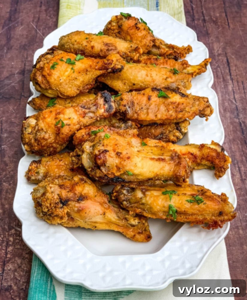 Freshly cooked air fryer keto fried chicken wings on a white plate