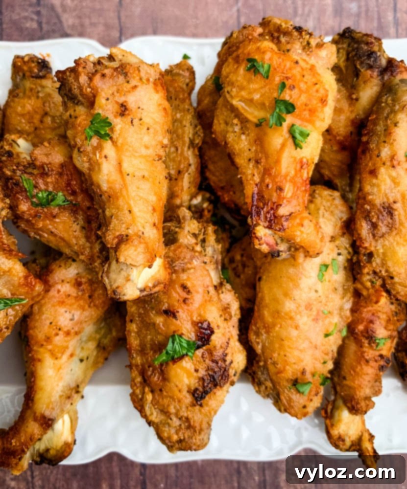 Serving of air fryer keto fried chicken wings on a white plate