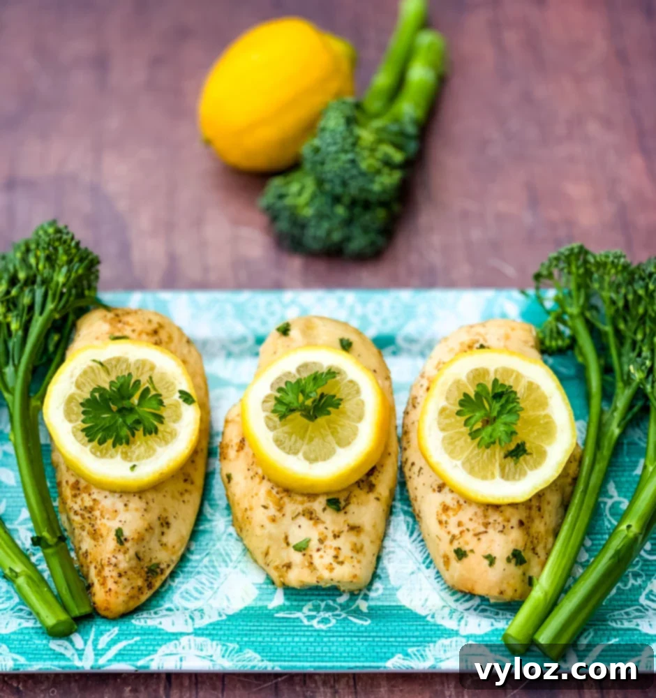 air fryer chicken breast on a blue plate with broccoli and lemons