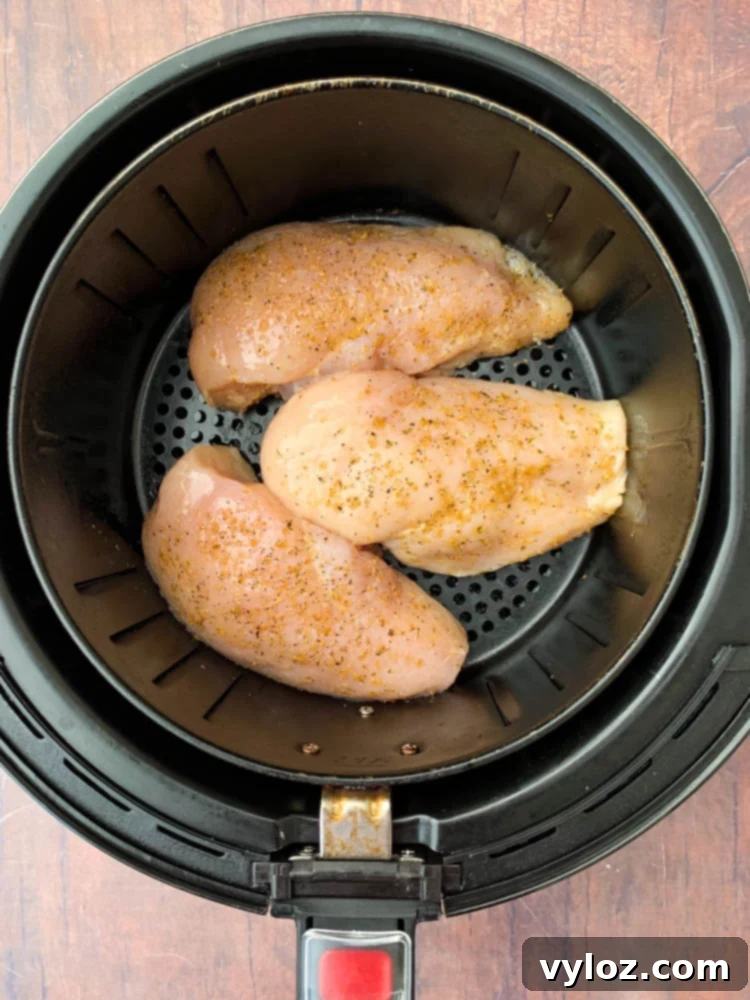 raw chicken breasts in an air fryer