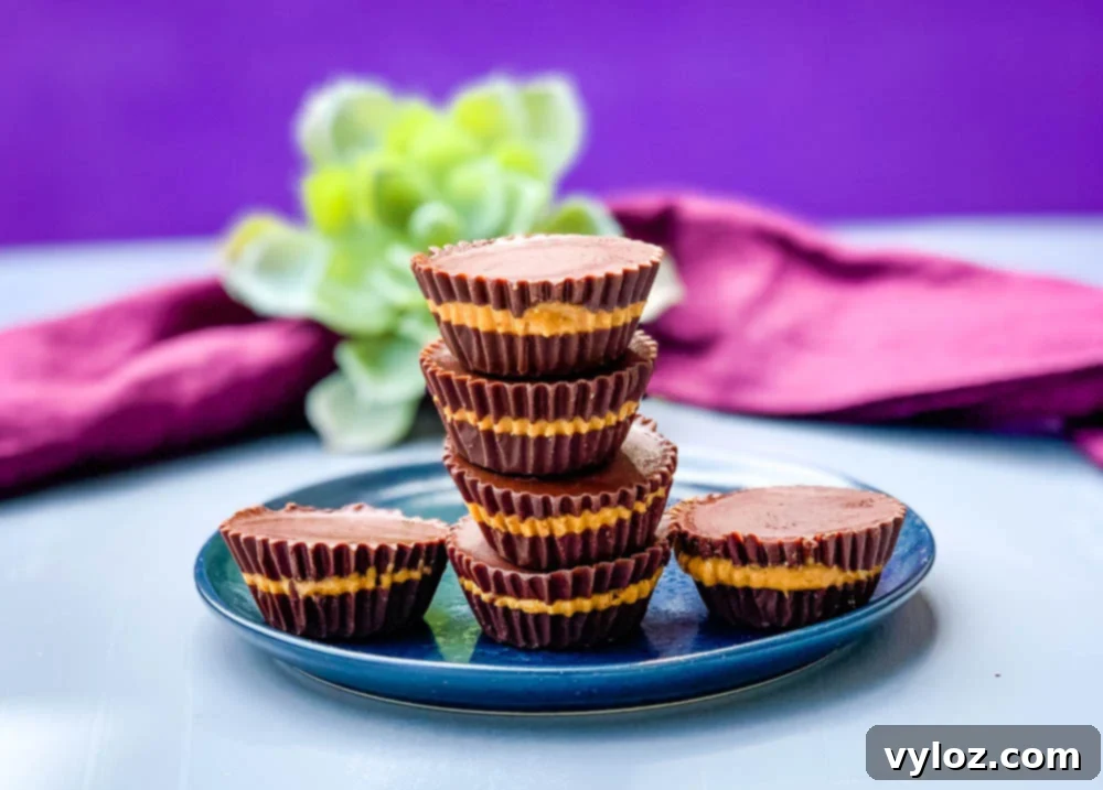 Keto Sugar-Free Peanut Butter Cups on a blue plate, garnished with a few chocolate shavings.