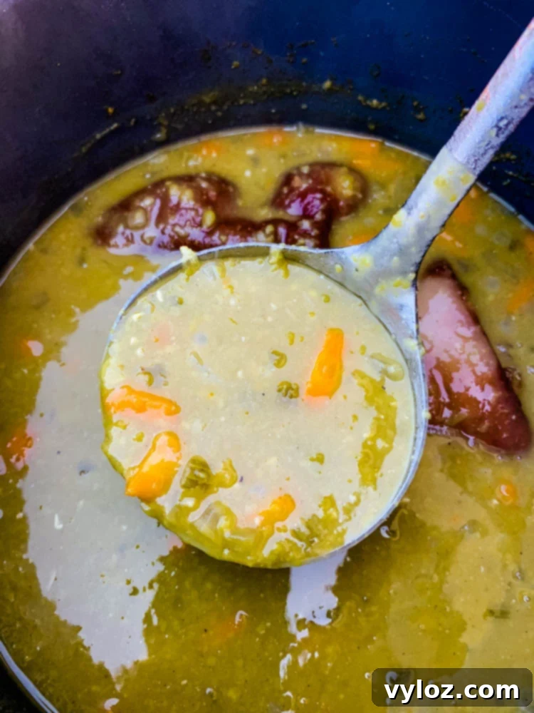 Freshly cooked and steaming split pea soup inside an Instant Pot, showing its rich, thick texture.