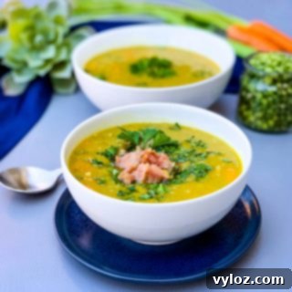 A beautifully presented bowl of Easy Instant Pot Split Pea Soup with ham, on a blue plate.