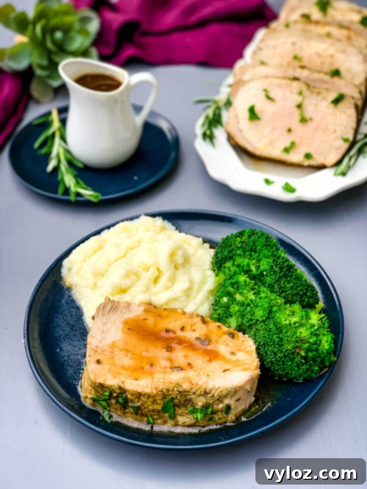 Instant Pot Pork Loin on a blue plate with cauliflower mash and broccoli