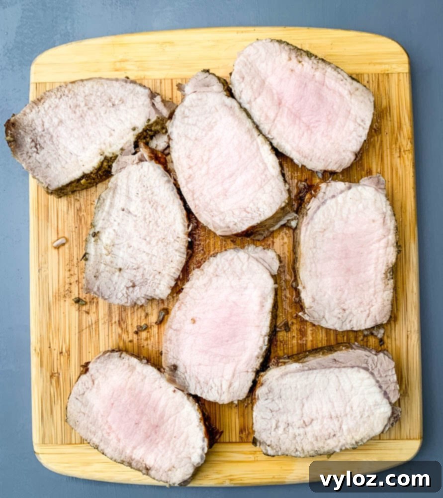cooked sliced Instant Pot pork loin on a cutting board