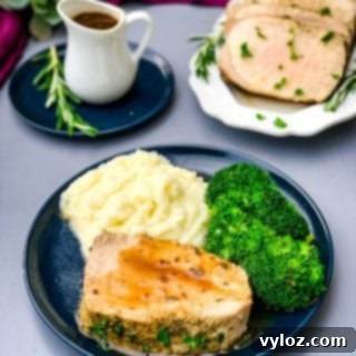 Instant Pot Pork Loin on a blue plate with cauliflower mash and broccoli