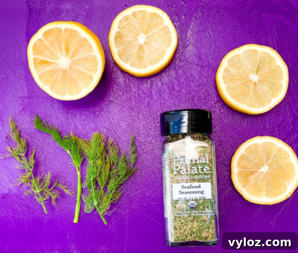 Perfectly Pan-Seared Salmon 3 Fresh lemon and dill arranged on a purple cutting board next to a bottle of seasoning, ready for pan-seared salmon