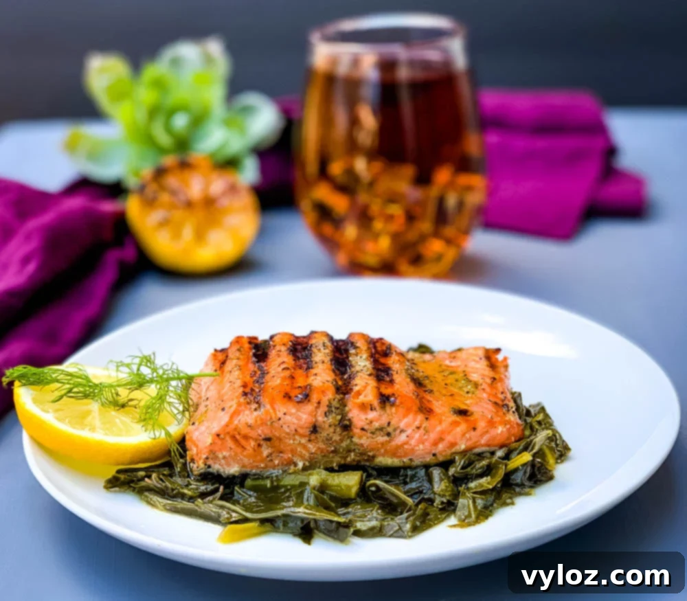 Perfectly Pan-Seared Salmon 8 Close-up of pan-seared cast iron salmon on a white plate with greens, highlighting the crispy skin