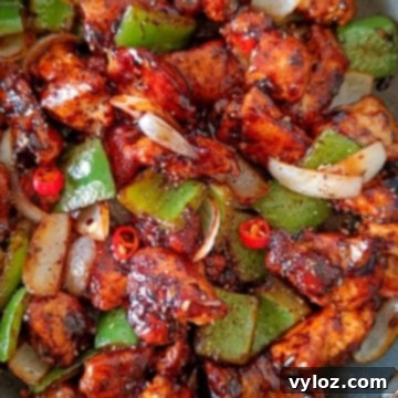 Quick and Easy Black Pepper Chicken 6 Image showing black pepper chicken with crunchy onion and bell peppers.