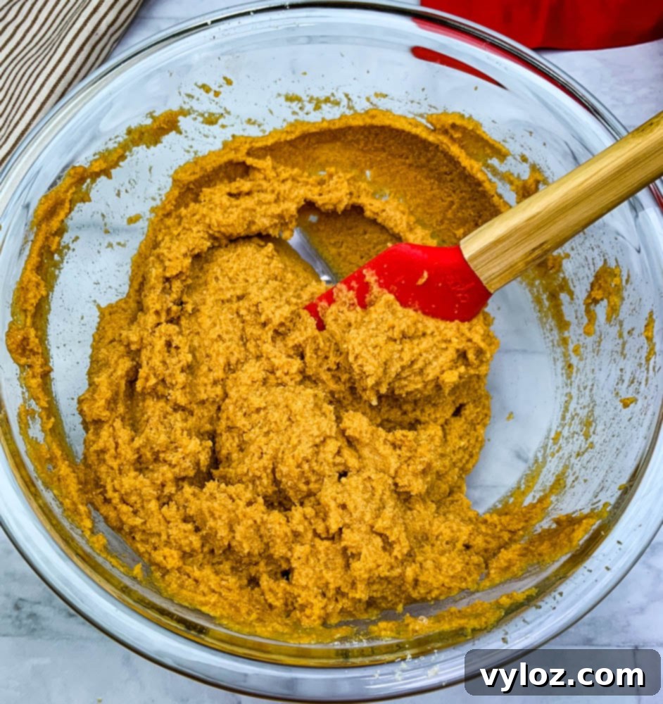 Keto low carb pumpkin bread batter in a glass mixing bowl, ready for baking
