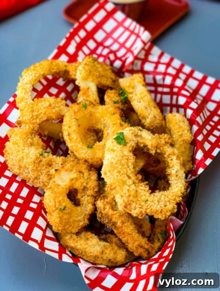 air fryer crispy onion rings in a bowl with a red wrapper