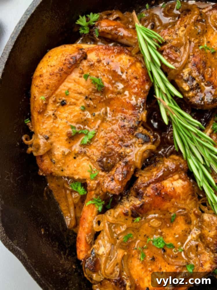 Smothered Keto Pork Chops 10 Keto low carb smothered pork chops in a cast iron skillet with a side of green vegetables