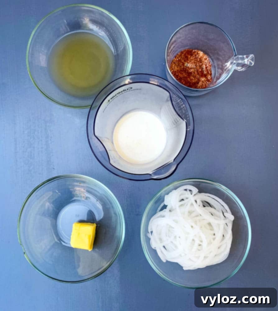 Smothered Keto Pork Chops 4 Ingredients for keto smothered pork chops: heavy cream, chicken broth, sliced onions, seasonings, and butter in glass bowls