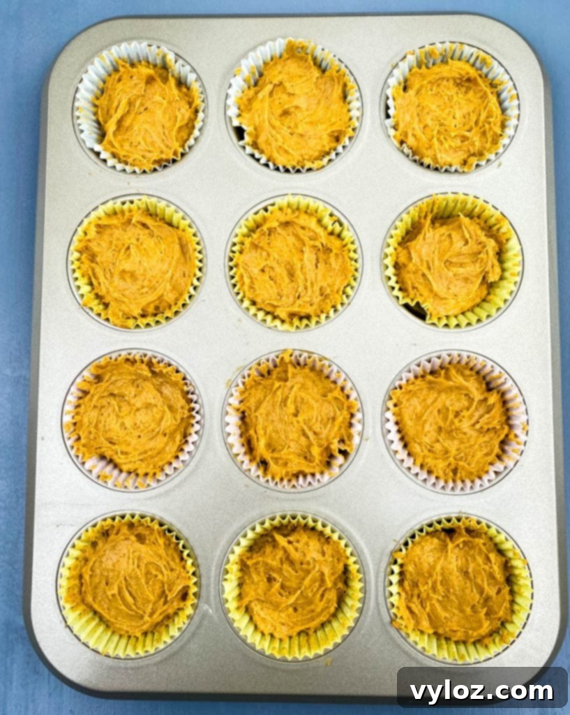 keto pumpkin muffins unbaked in a muffin tin