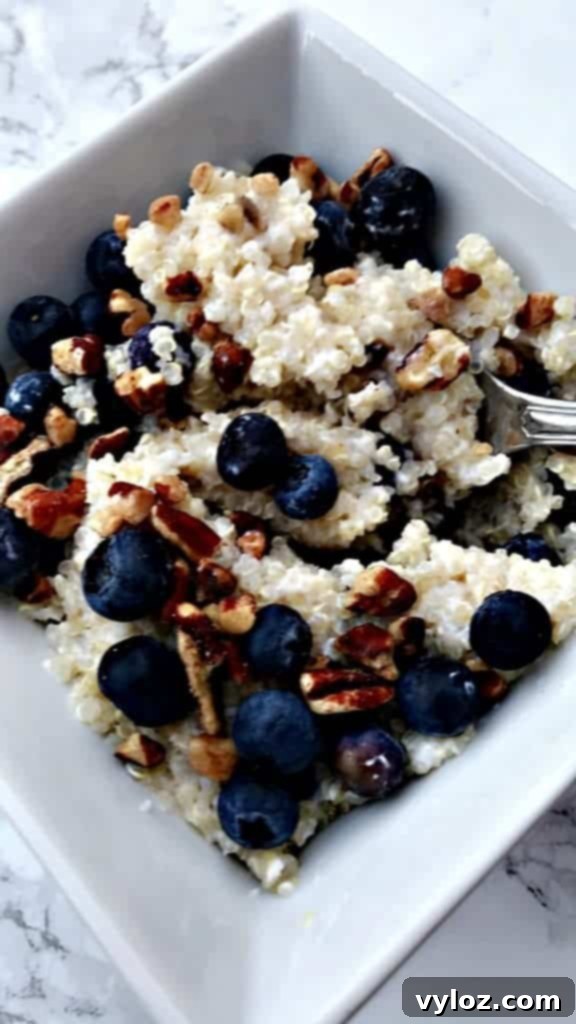 A vibrant 5-minute blueberry quinoa breakfast bowl garnished with fresh blueberries and pecans.