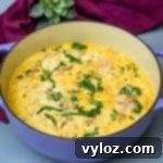 keto low carb zuppa toscana soup in a purple cast iron Dutch oven