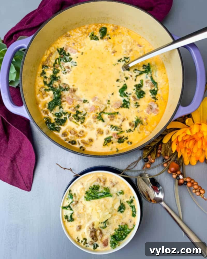 keto low carb zuppa toscana soup in a purple cast iron Dutch oven with a bowl of soup in a white bowl