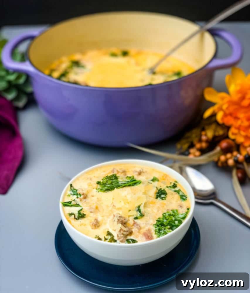 keto low carb zuppa toscana soup in a purple cast iron Dutch oven with a bowl of soup in a white bowl