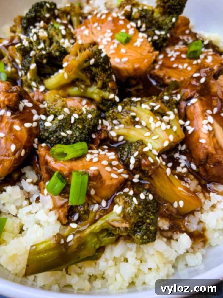 Instant Pot teriyaki chicken in a white bowl with chopsticks