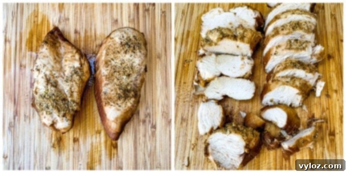 Cooked and sliced chicken breasts on a bamboo cutting board, ready to be served