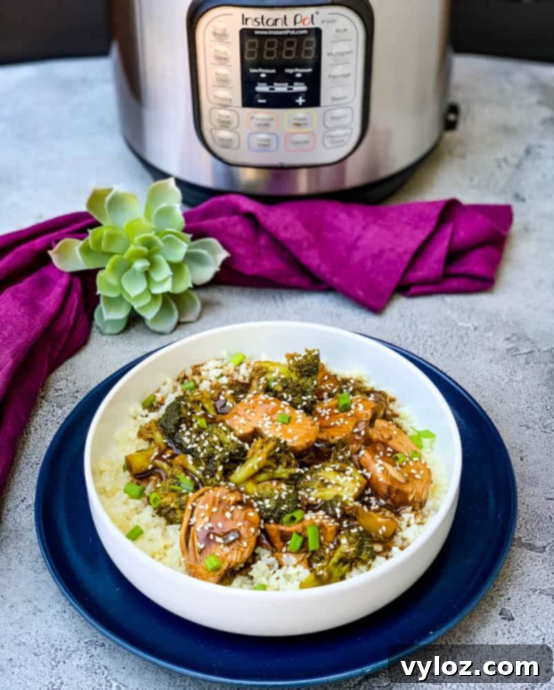 Instant Pot teriyaki chicken in a white bowl, ready to be served