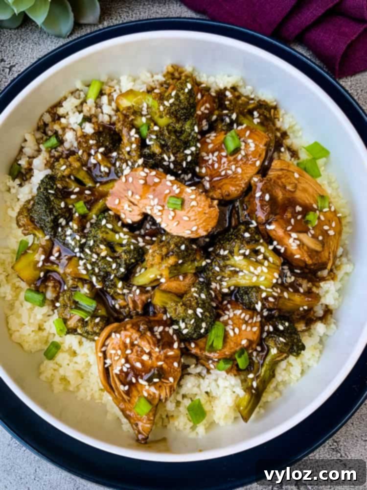 Instant Pot teriyaki chicken in a white bowl, garnished with green onions