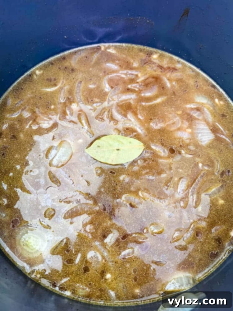 Effortless Instant Pot French Onion Soup 6 French Onion Soup in an Instant Pot with a bay leaf